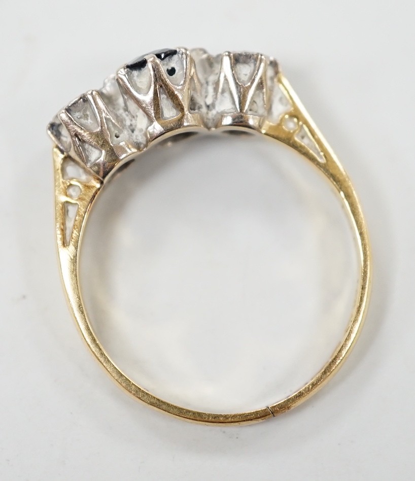 A modern 18ct gold, single stone sapphire and two stone illusion set diamond ring, size N, gross weight 3.4 grams.